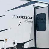 Brookstone RV with branding on a clear day